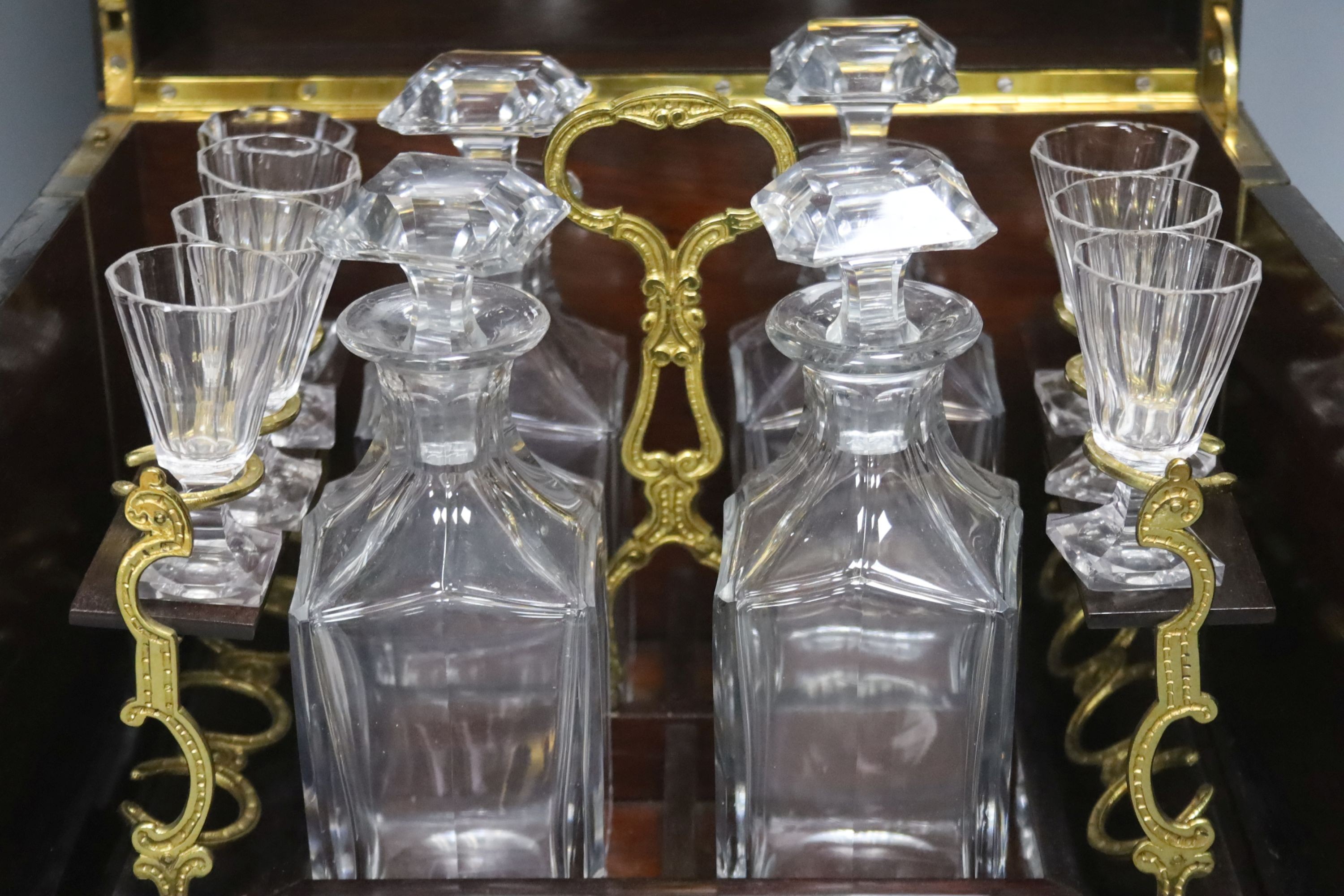 A mid-19th century French ebonised and brass-inlaid decanter case, fitted four decanters and seven glasses on removable tray (incomplete), W 35cm
